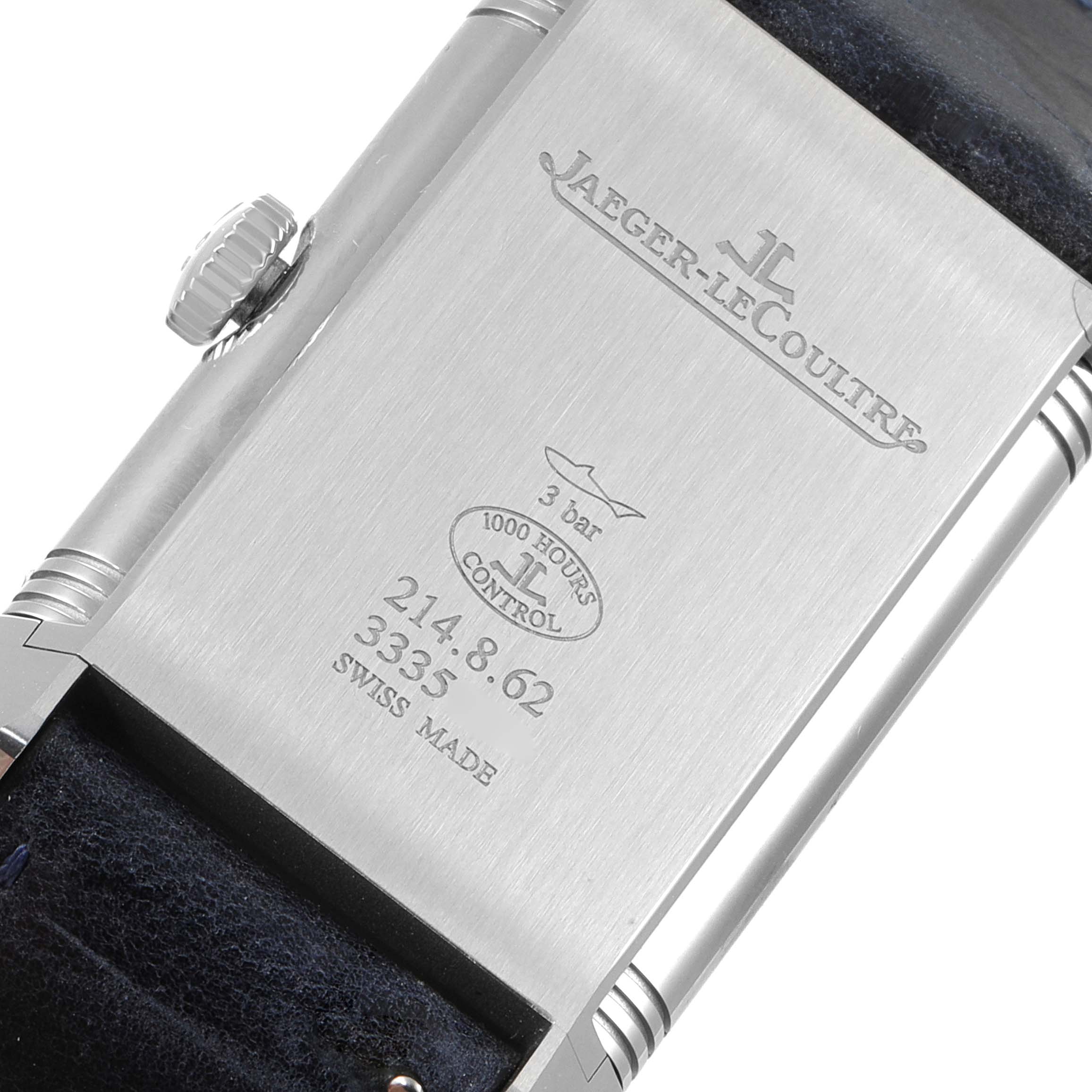The image shows the back of a Jaeger-LeCoultre Reverso watch, featuring the logo, water resistance rating, and serial numbers.