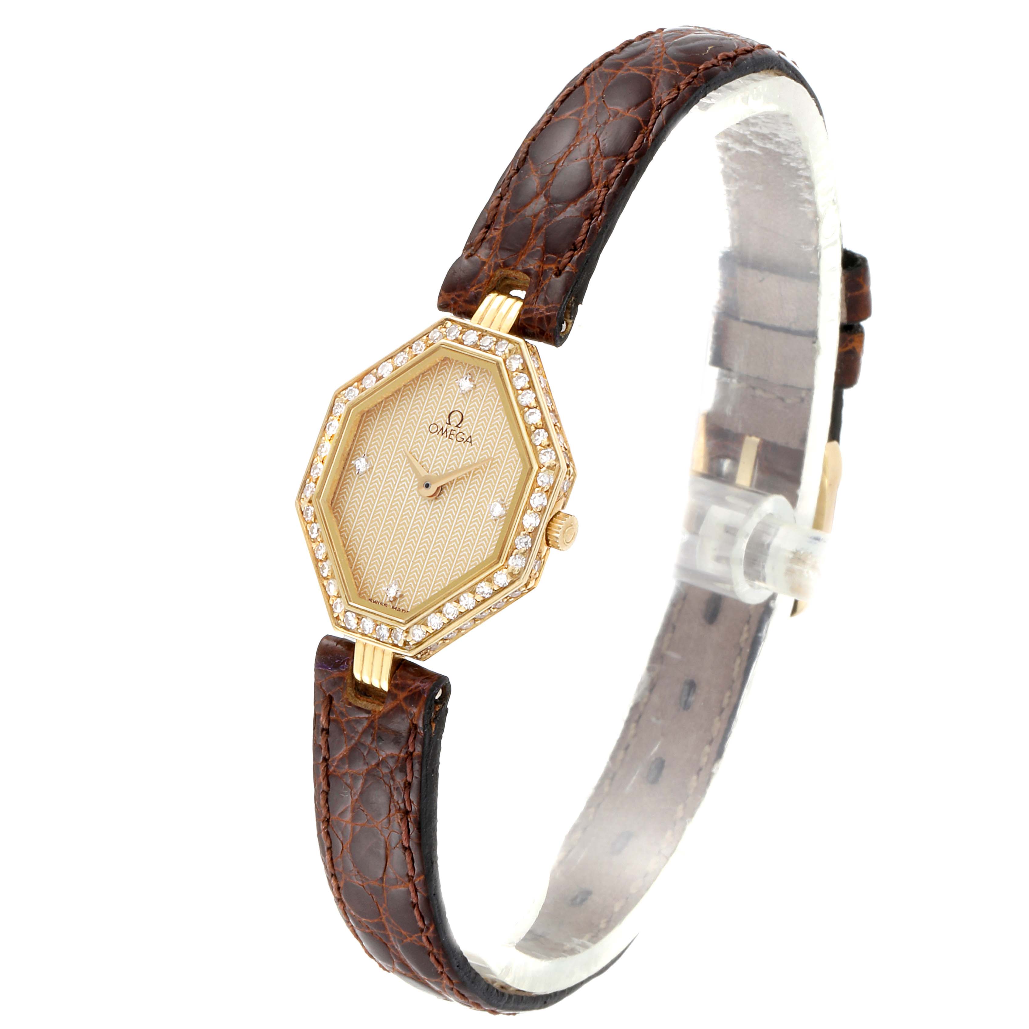 The DeVille Mini Yellow Gold Diamond Cocktail Ladies Watch 1450 model by Omega 1450 Women
s Yellow Gold Champagne Dial 1450 Women
s Yellow Gold Champagne Dial is shown from a front angle, highlighting the hexagonal face and brown strap.