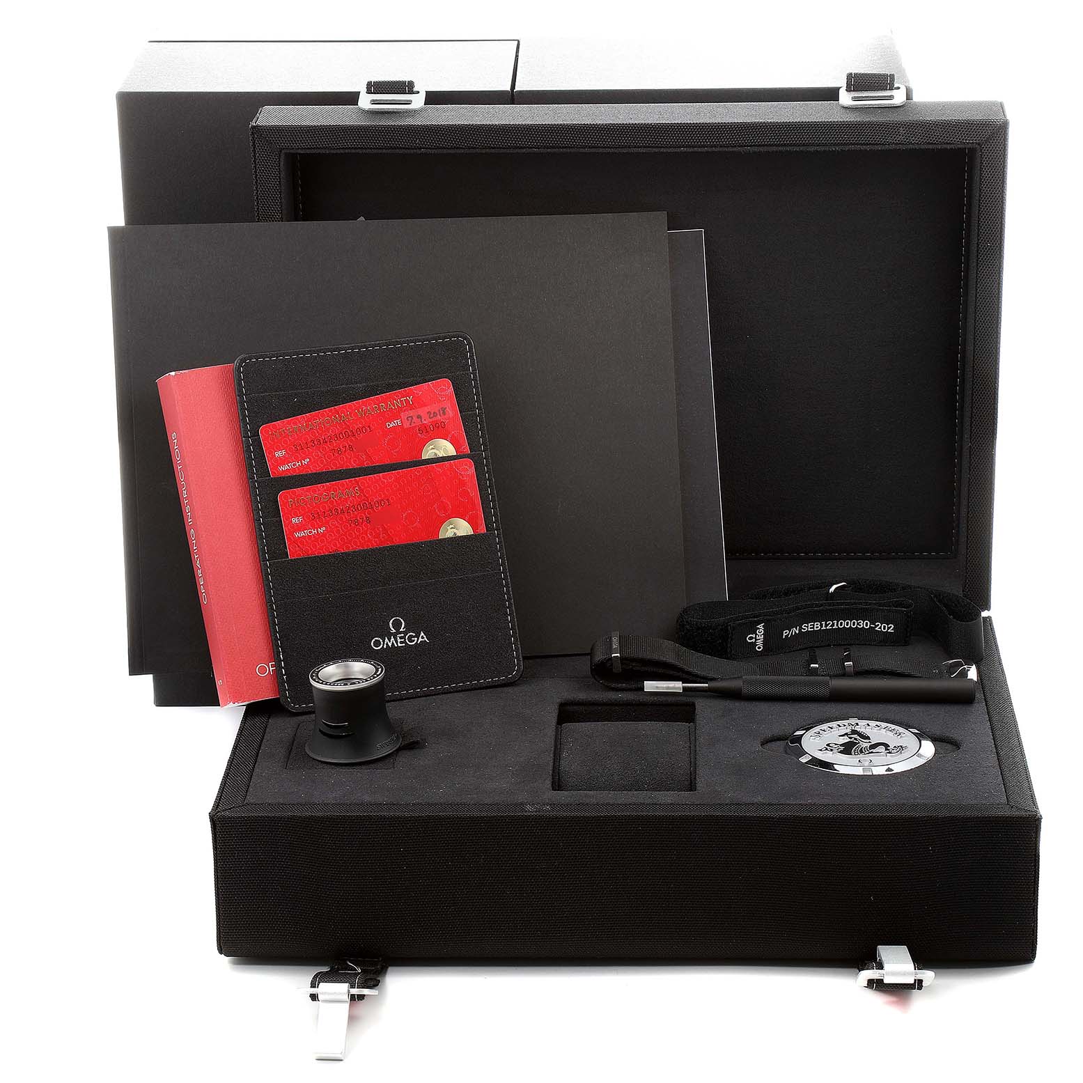 The image shows an Omega Speedmaster 311.33.42.30.01.001 Men's Stainless Steel Black Dial 311.33.42.30.01.001 Men's Stainless Steel Black Dial watch box with a warranty card holder, magnifying glass, strap, and booklet.