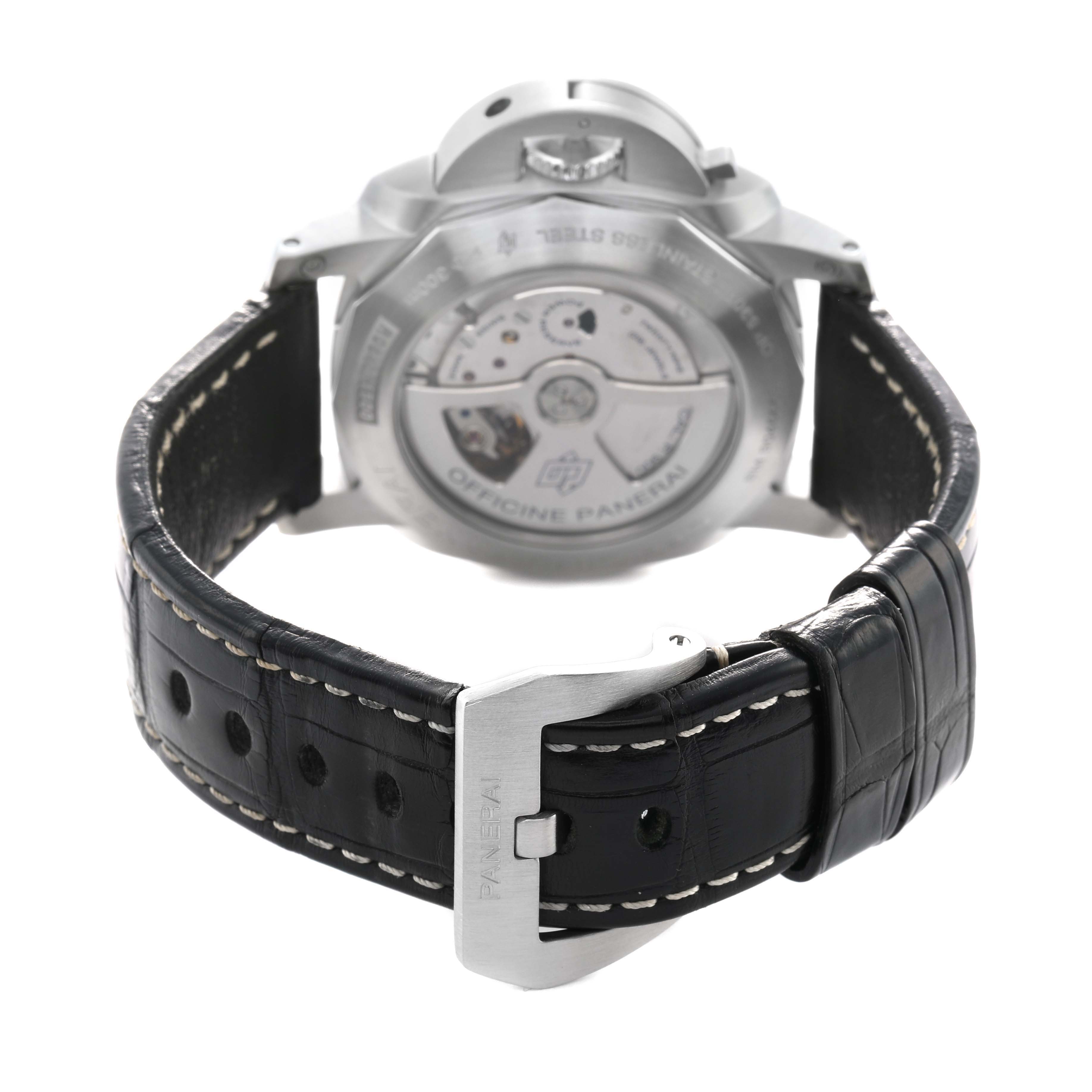 The image shows the back view of a Panerai Luminor PAM00320 Men's Stainless Steel Black Dial watch, highlighting the movement and a leather strap with a metal buckle.