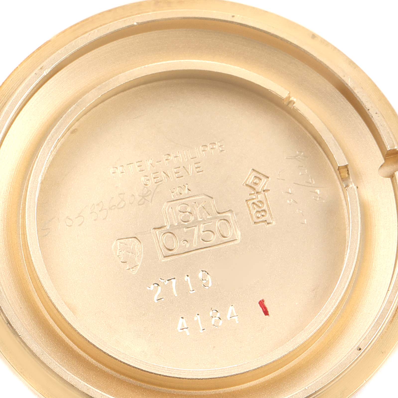 This is an inside view of the caseback for the Patek Philippe Calatrava 4184J Women's Yellow Gold Silver Dial 4184J Women's Yellow Gold Silver Dial watch, showing the hallmarks and engravings.