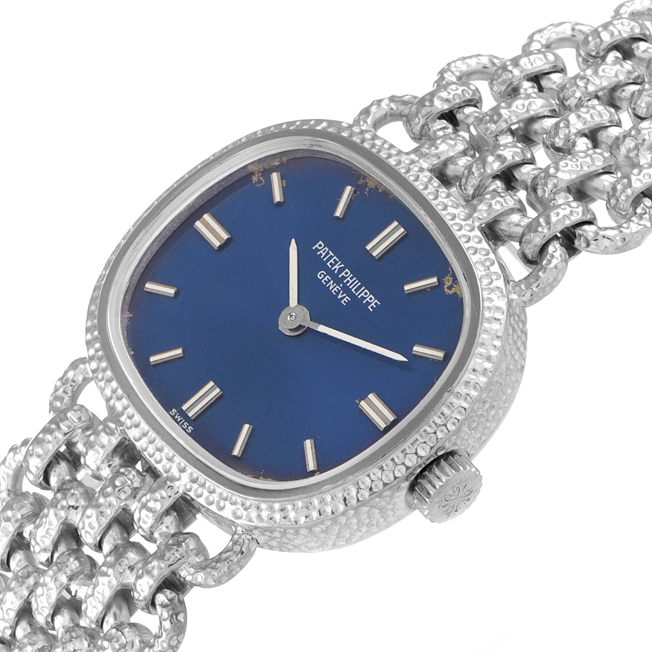 This image shows a close-up, angled view of the Patek Philippe Golden Ellipse 4133 Women's White Gold Blue Dial 4133 Women's White Gold Blue Dial watch, highlighting the blue dial and intricate silver band.