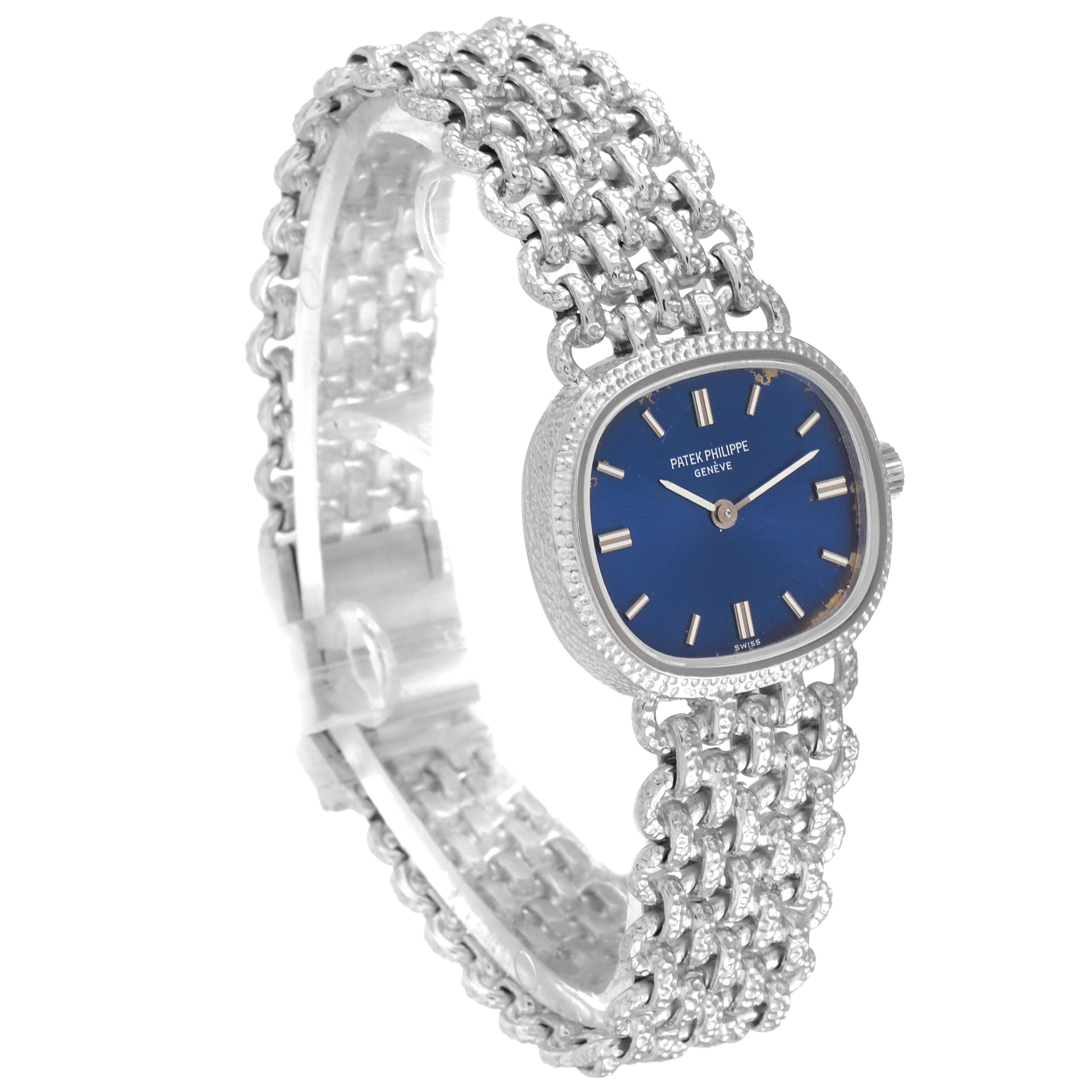 The image shows a Patek Philippe Golden Ellipse 4133 Women's White Gold Blue Dial 4133 Women's White Gold Blue Dial watch with a blue dial and a woven metal bracelet, viewed at a slight angle from the front-left.