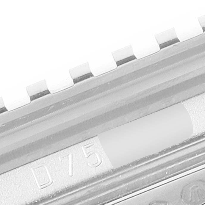 This image shows a close-up angle of a part of the Rolex Cellini 5441 Men's White Gold Silver Dial 5441 Men's White Gold Silver Dial watch, specifically the bezel with marked engravings.