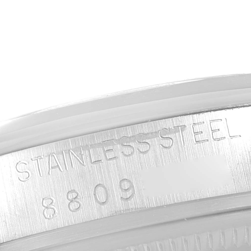 The image shows a close-up of the stainless steel case back of the Vintage Collection model by Rolex, revealing the engraved serial number.