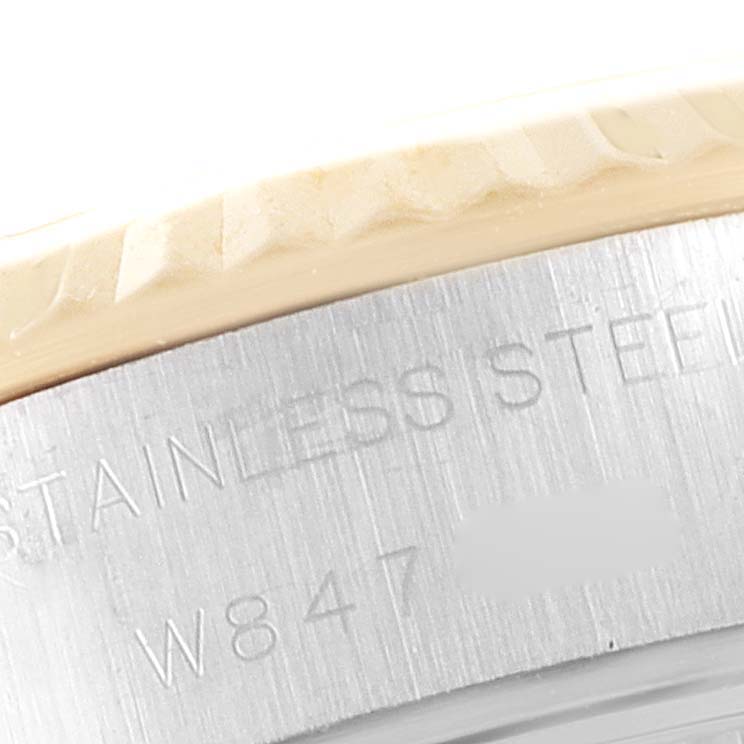This image shows a close-up of the stainless steel part of a Rolex Datejust 69173 Women's Steel and Gold (two tone) Champagne Dial 69173 Women's Steel and Gold (two tone) Champagne Dial watch, including part of its engraved serial number.