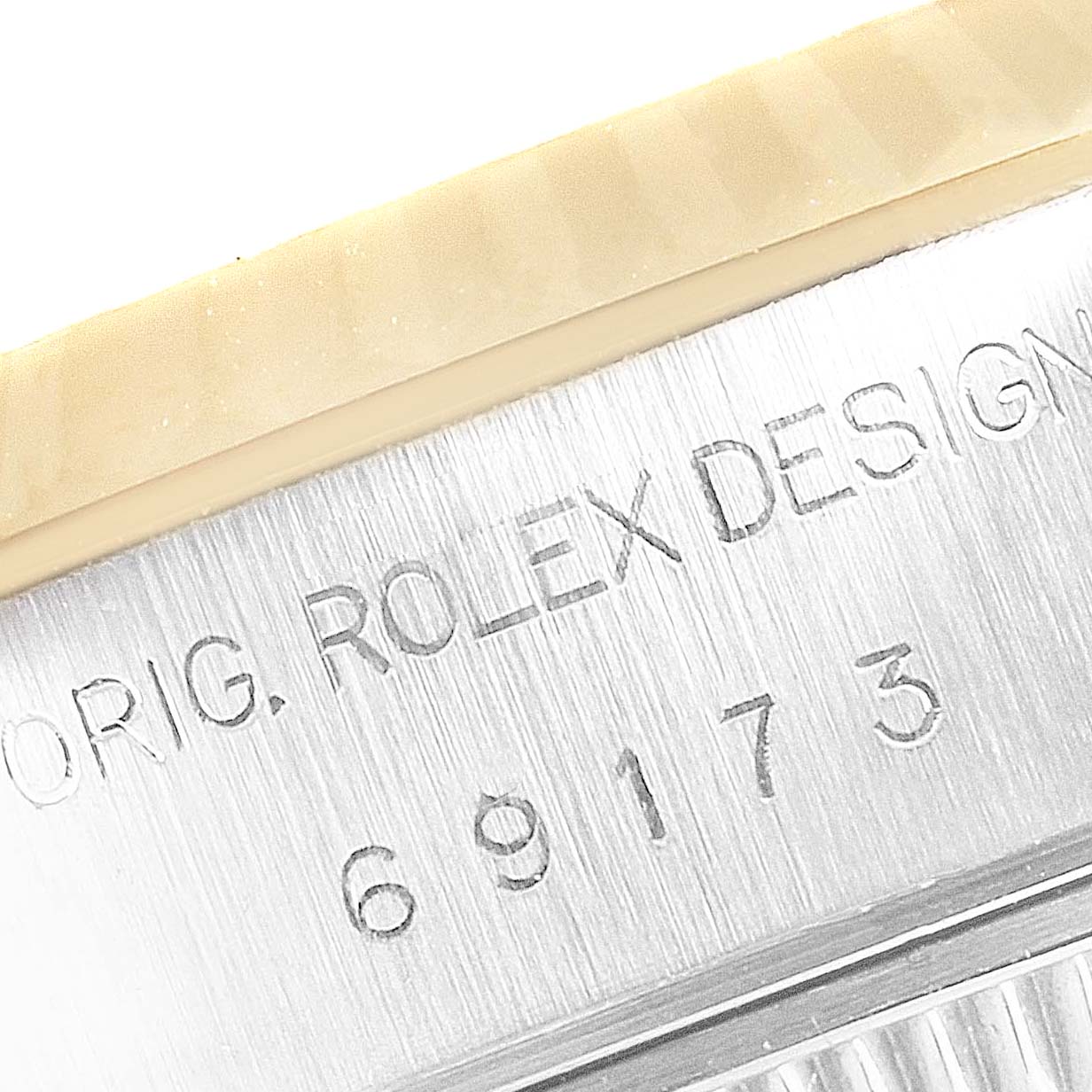 This close-up image shows the serial number and part of the bezel from the Rolex Datejust 69173 Women's Steel and Gold (two tone) Champagne Dial 69173 Women's Steel and Gold (two tone) Champagne Dial model.
