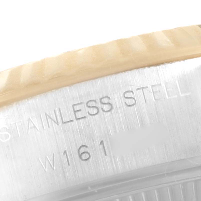 This close-up image shows the edge of the case and bezel of a Rolex Datejust 69173 Women's Steel and Gold (two tone) Blue Dial 69173 Women's Steel and Gold (two tone) Blue Dial watch with "STAINLESS STEEL" engraving.