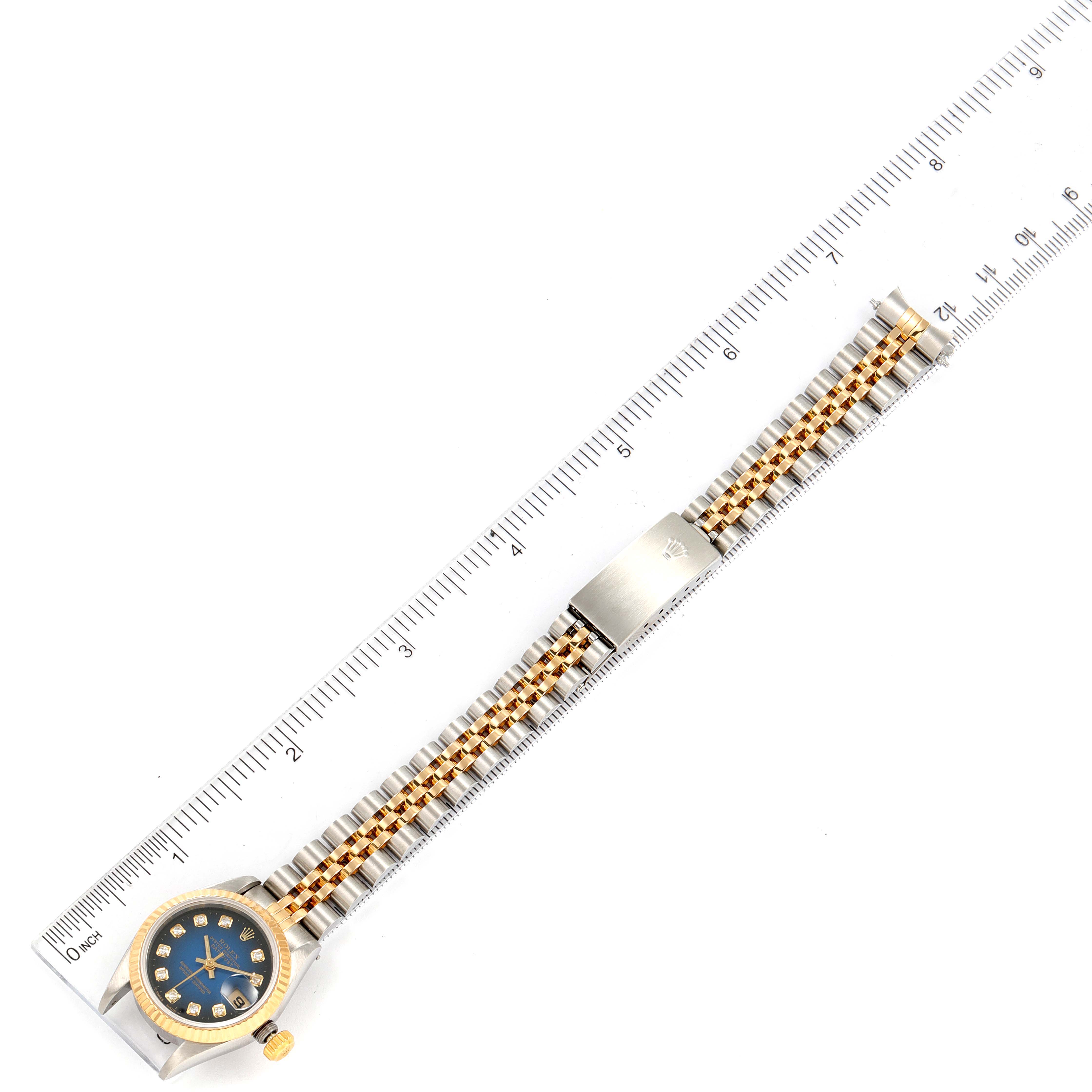 This image shows a top-down view of a Rolex Datejust 69173 Women's Steel and Gold (two tone) Blue Dial 69173 Women's Steel and Gold (two tone) Blue Dial watch, focusing on its bezel, dial, and the full length of its bracelet.