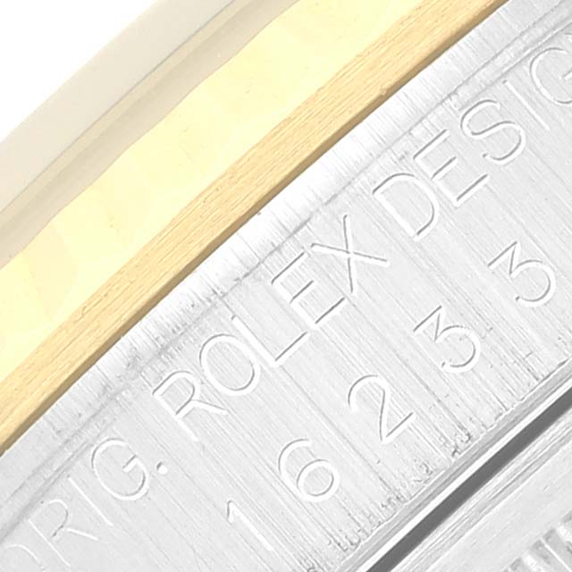 The image shows a macro view of the engraved watch case and bezel of a Rolex Datejust 16233 Men's Steel and Gold (two tone) Blue Dial 16233 Men's Steel and Gold (two tone) Blue Dial model, highlighting the "ROLEX DESIGN" text and serial number.