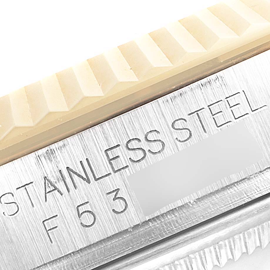 This close-up image shows the stainless steel part of the bezel and case back of a Rolex Datejust 116233 Men's Steel and Gold (two tone) Champagne Dial 116233 Men's Steel and Gold (two tone) Champagne Dial model watch.