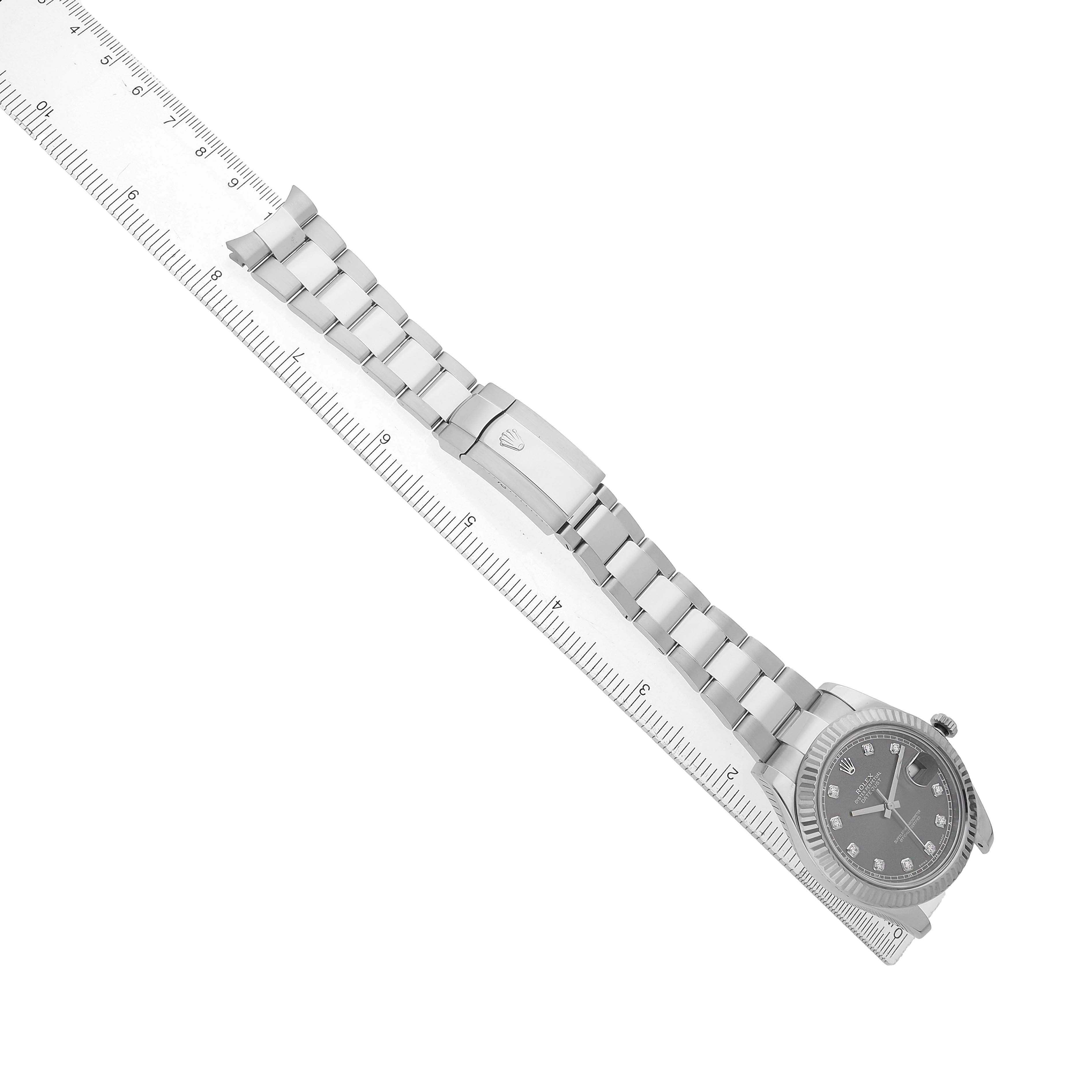 The Rolex Datejust 41 116334 Men's Stainless Steel Silver Dial watch is shown diagonally, displaying the face, bracelet, and clasp with a ruler for scale.