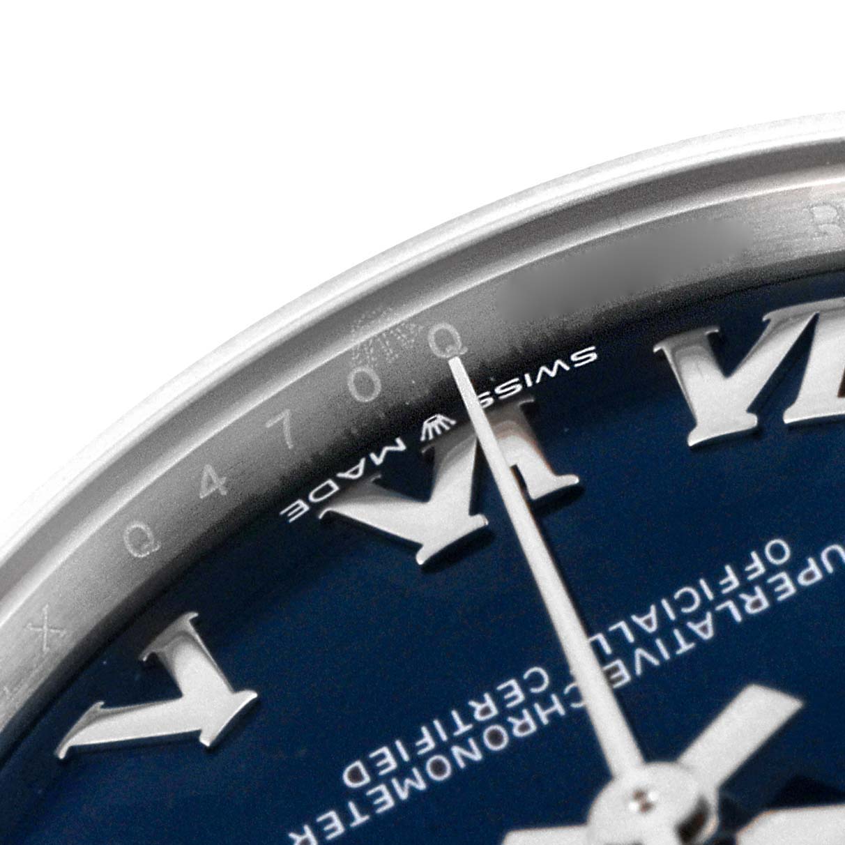 The image shows a close-up of the dial and bezel of a Rolex Mid-Size 278274 Women
s Stainless Steel Blue Dial 278274 Women
s Stainless Steel Blue Dial model, focusing on the Roman numerals and second hand.