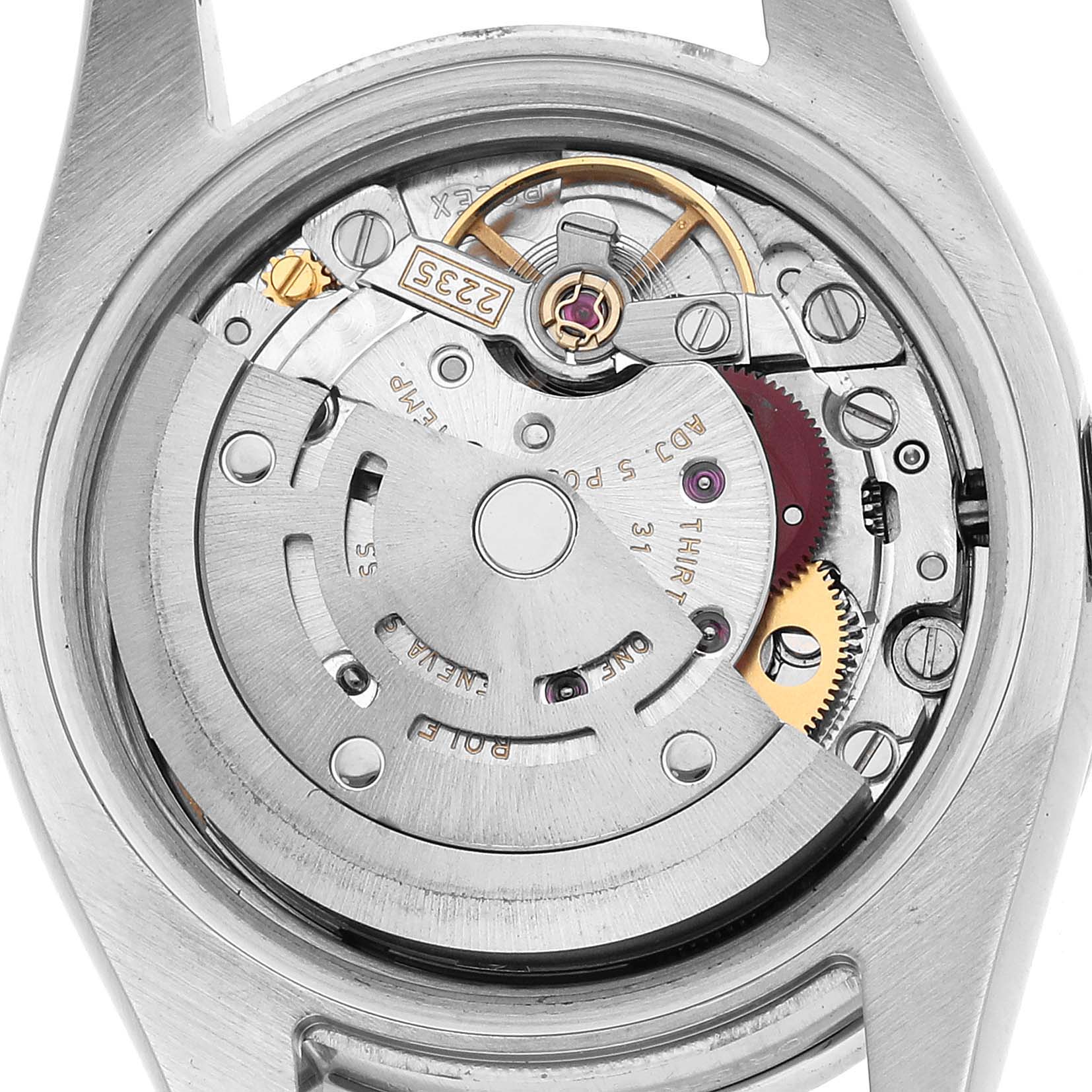 The image shows a top view of the Rolex Datejust 179384 Women's Stainless Steel Pink Dial watch's movement, highlighting gears and mechanical components.