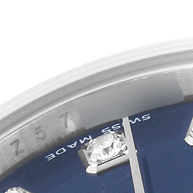The image shows a close-up of the dial of a Rolex Datejust 179174 Women's Stainless Steel Blue Dial 179174 Women's Stainless Steel Blue Dial watch, highlighting a diamond hour marker and part of the text "SWISS MADE."