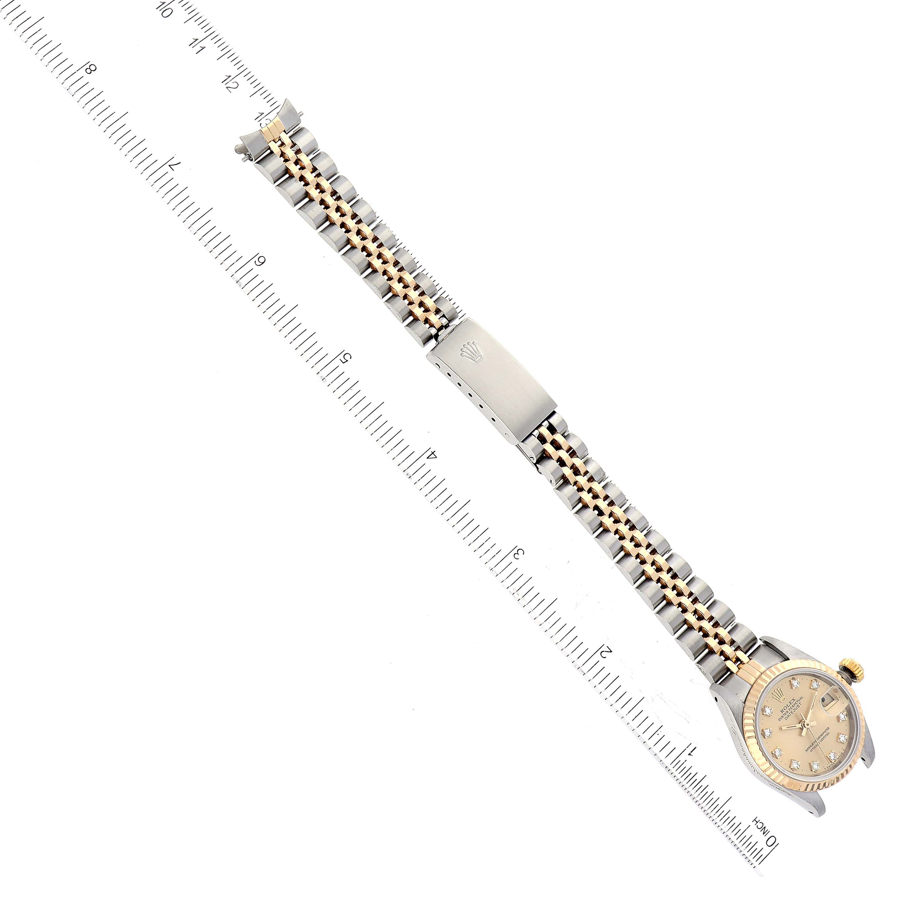 The image shows a Rolex Datejust 69173G Women's Steel and Gold (two tone) Champagne Dial 69173G Women's Steel and Gold (two tone) Champagne Dial watch laid flat with a ruler, displaying its dial, bezel, bracelet, and clasp.