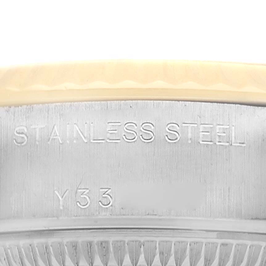 This image shows a close-up side view of a Rolex Datejust 79173 Women's Steel and Gold (two tone) Black Dial watch, highlighting the stainless steel engraving on the case.