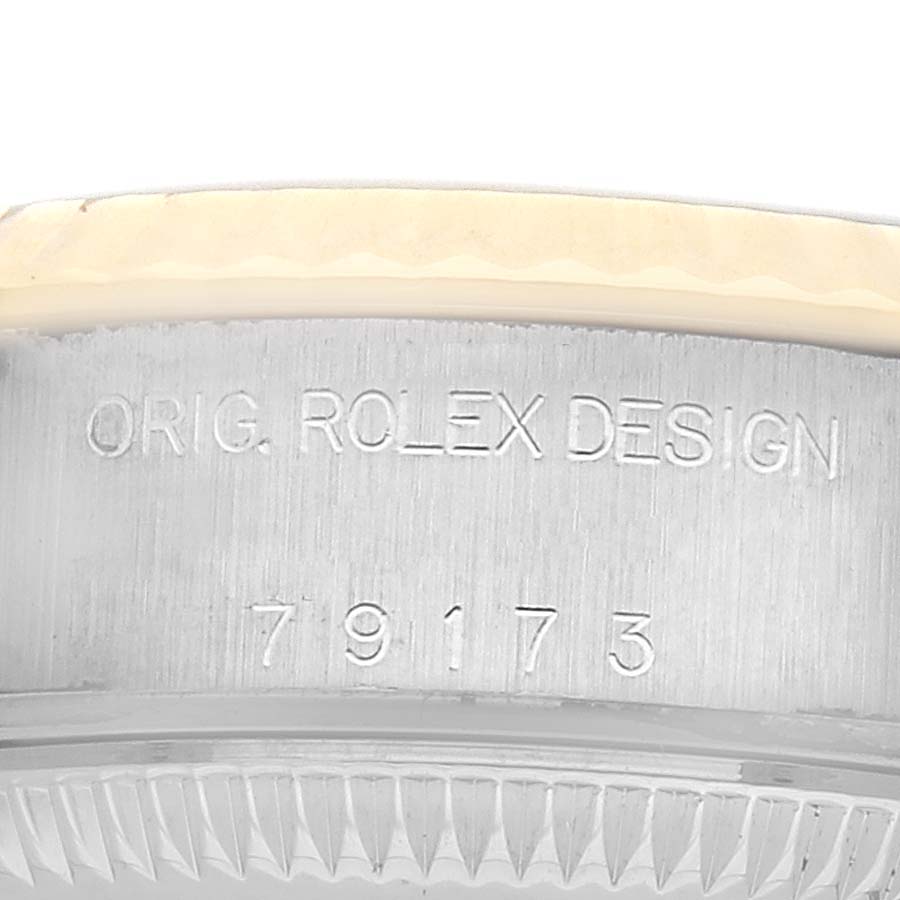 The image shows the side view of a Rolex Datejust 79173 Women's Steel and Gold (two tone) Black Dial model case with engraved markings.