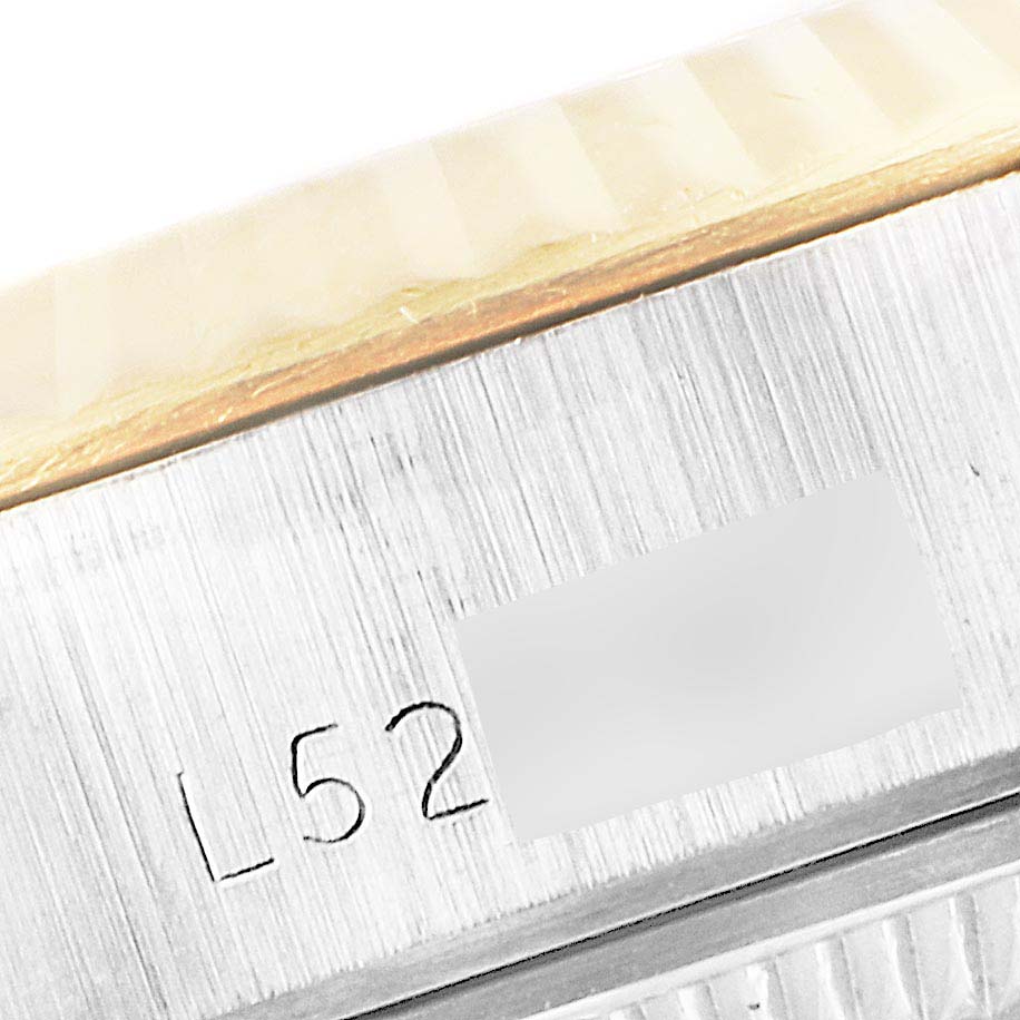 This close-up shows the serial number engraving and fluted bezel of the Rolex Datejust 69173 Women's Steel and Gold (two tone) Champagne Dial 69173 Women's Steel and Gold (two tone) Champagne Dial watch.