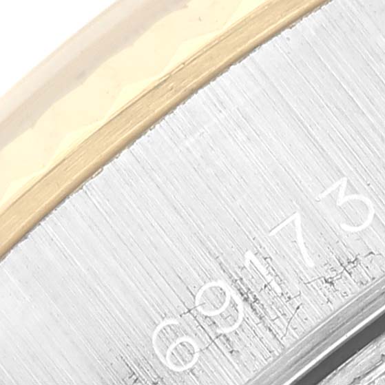 This close-up image shows the serial number part of the steel case-back of a Rolex Datejust 69173 Women's Steel and Gold (two tone) White Dial 69173 Women's Steel and Gold (two tone) White Dial watch.