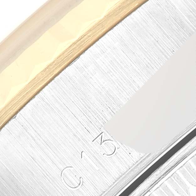 The image shows a close-up of the edge and part of the bezel of a Rolex Datejust 69173 Women's Steel and Gold (two tone) White Dial 69173 Women's Steel and Gold (two tone) White Dial watch, highlighting the metallic finish and engravings.