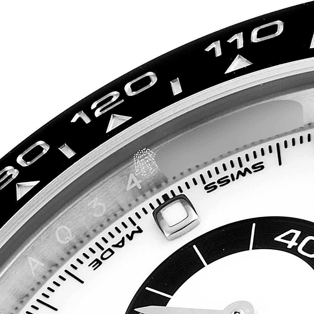 This image shows a close-up of the dial and bezel of a Rolex Daytona 116500 Men's Stainless Steel White Dial 116500 Men's Stainless Steel White Dial watch, focusing on the tachymeter scale and part of the sub-dial.