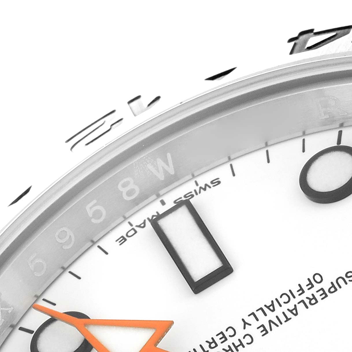 This close-up image shows parts of the dial, hour markers, and orange hand of the Rolex Explorer 216570 Men's Stainless Steel White Dial 216570 Men's Stainless Steel White Dial watch model.