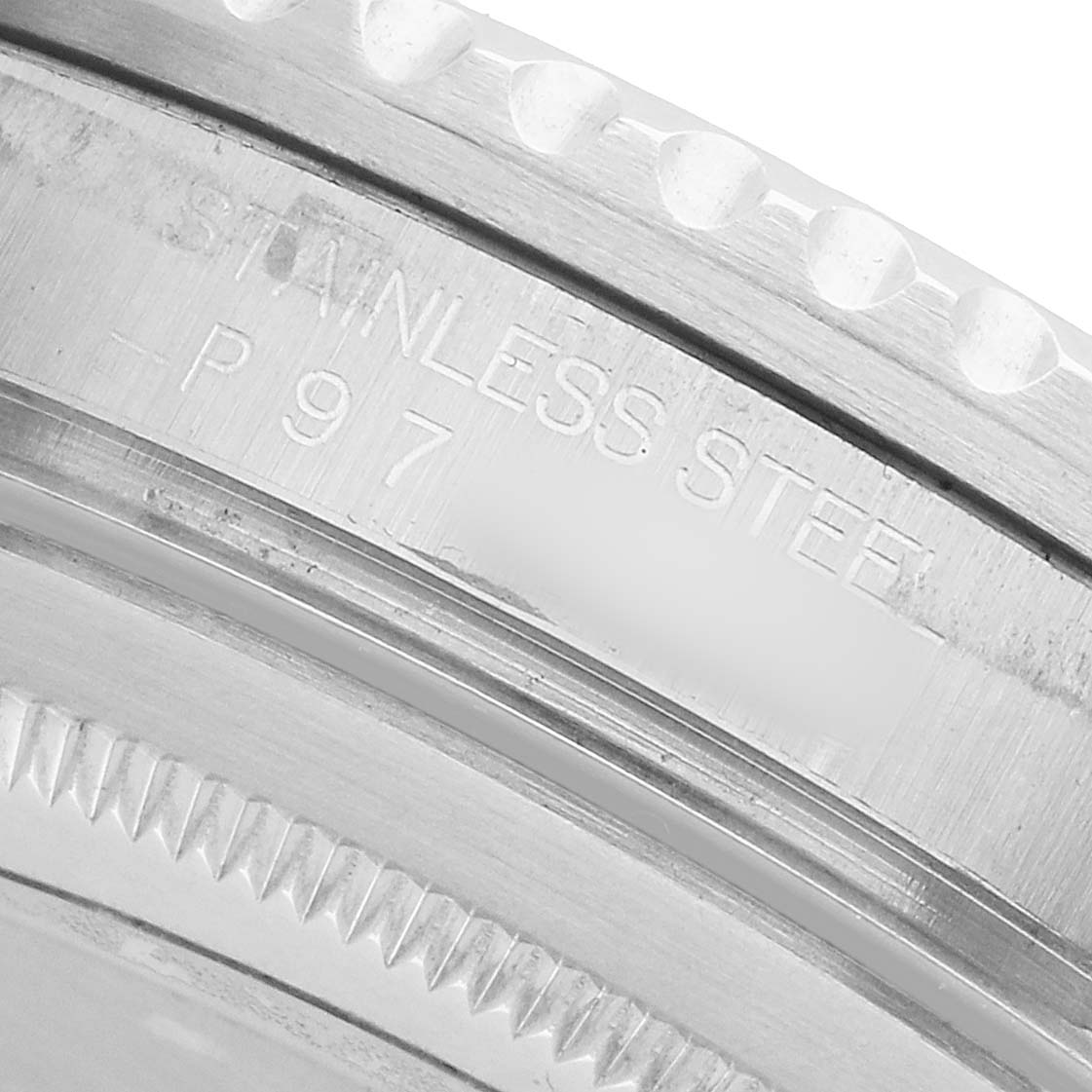 The image shows a close-up of the stainless steel bezel and edge engraving on a Rolex GMT-Master 16710 Men's Stainless Steel Black Dial watch.