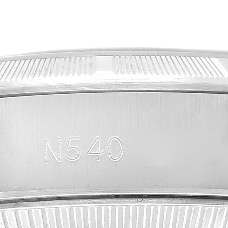 This image shows a close-up of the bezel with the engraving "N540" on a Rolex Oyster Perpetual 67230 Women's Stainless Steel Silver Dial 67230 Women's Stainless Steel Silver Dial watch.