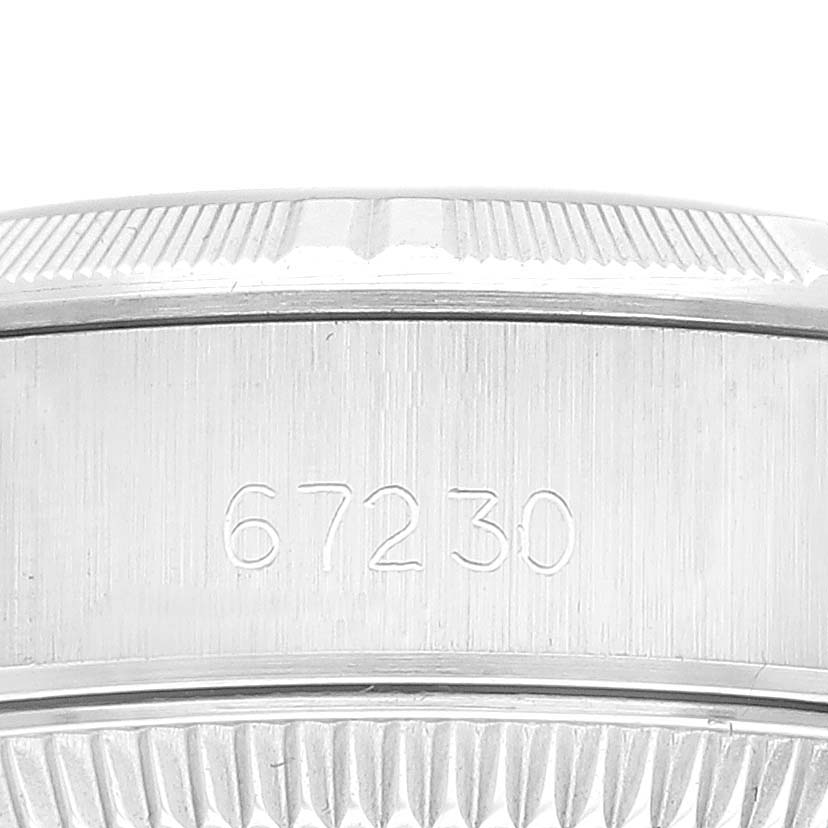 This image shows a close-up of the side of a Rolex Oyster Perpetual 67230 Women's Stainless Steel Silver Dial 67230 Women's Stainless Steel Silver Dial watch case, featuring the model number 67230.