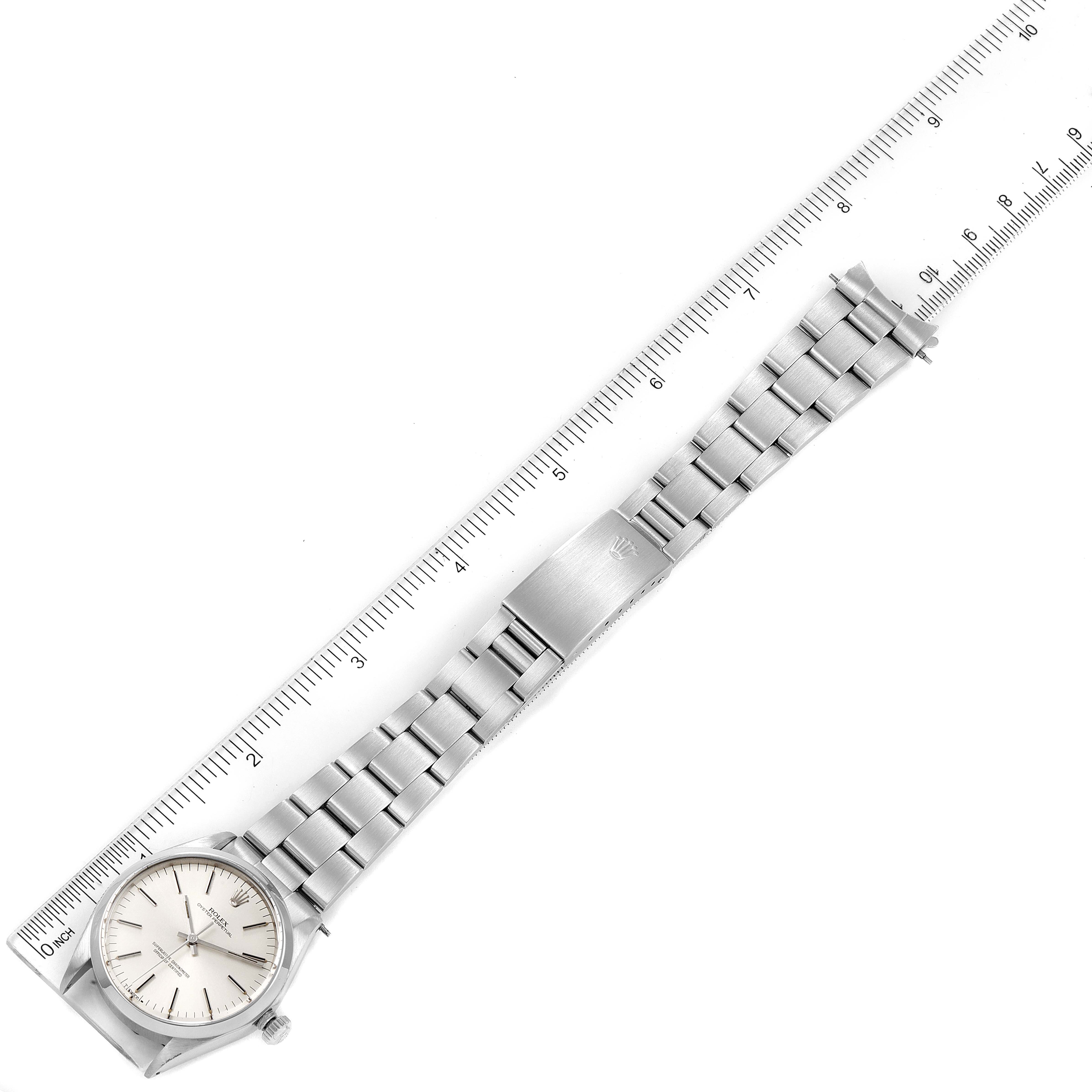 The Rolex Vintage Collection 1002 Men's Stainless Steel Silver Dial 1002 Men's Stainless Steel Silver Dial watch is displayed horizontally with the dial, case, and full bracelet visible, alongside a ruler.