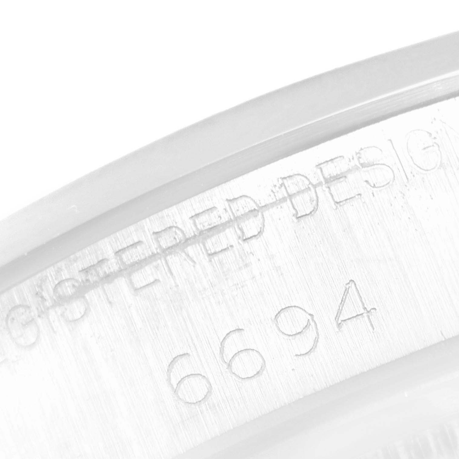 This image shows a close-up of the caseback engraving on the Vintage Collection model by Rolex, highlighting the reference number 6694.