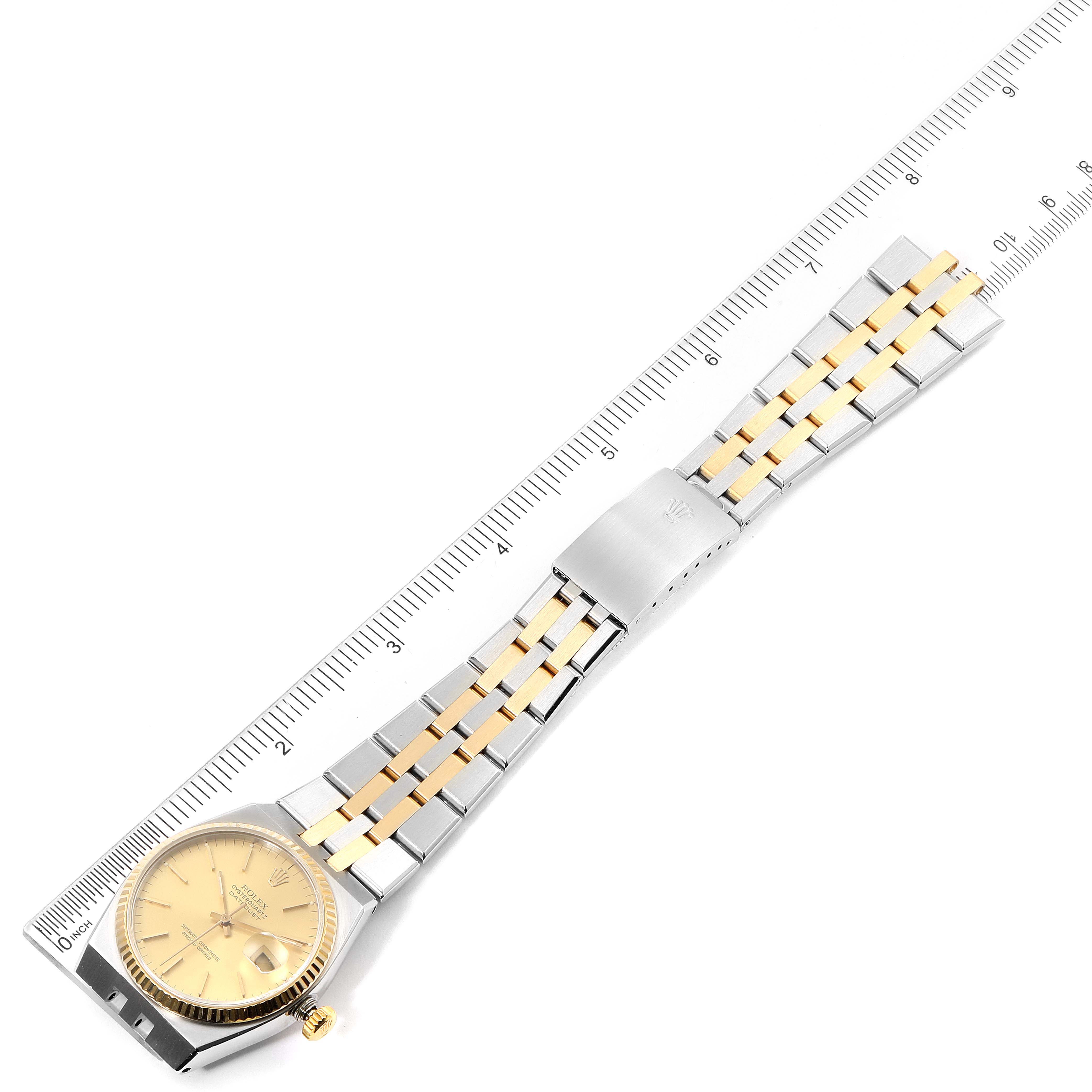 The image shows a top view of the Rolex Oysterquartz 17013 Men's Steel and Gold (two tone) Champagne Dial 17013 Men's Steel and Gold (two tone) Champagne Dial watch, including the face, bracelet, and clasp, with a ruler for scale.