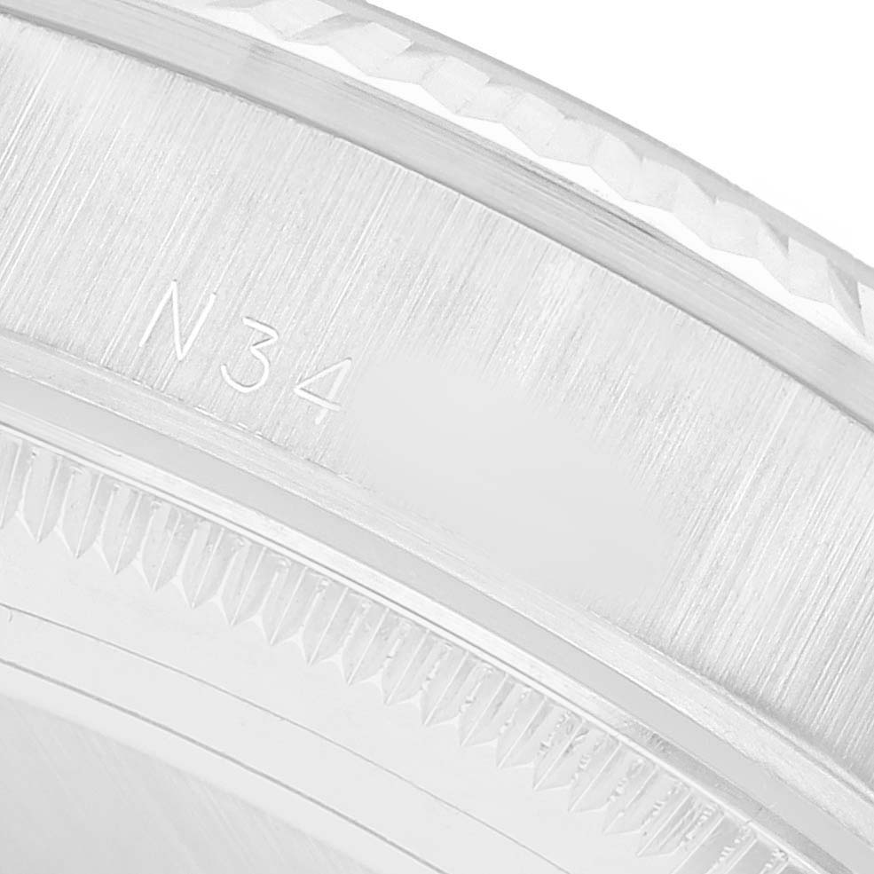 The image shows a close-up of the bezel side of the Rolex President 68279 Women's White Gold Silver Dial watch, highlighting the engraved serial number.