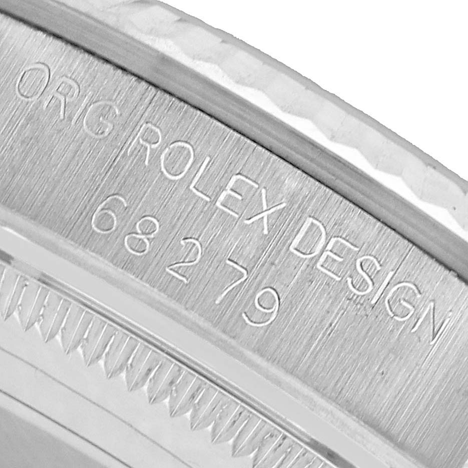 The image shows a close-up of the bezel edge and engraved inside case markings on a Rolex President 68279 Women's White Gold Silver Dial watch.