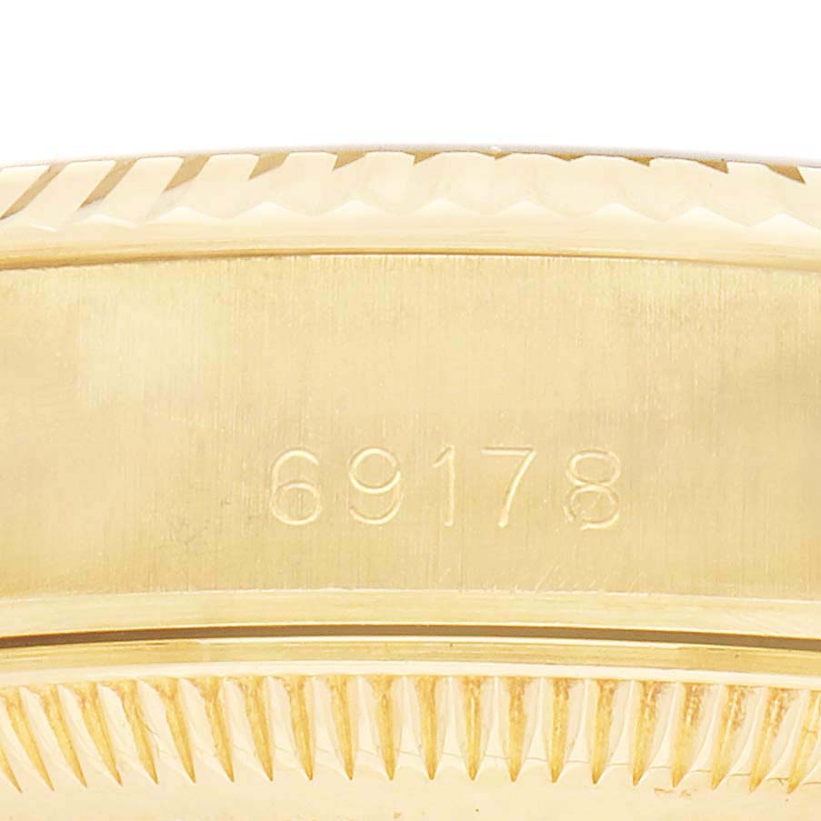 The image shows a close-up of the side of a Rolex President 69178 Women's Yellow Gold Black Dial watch, focusing on the engraved model number.