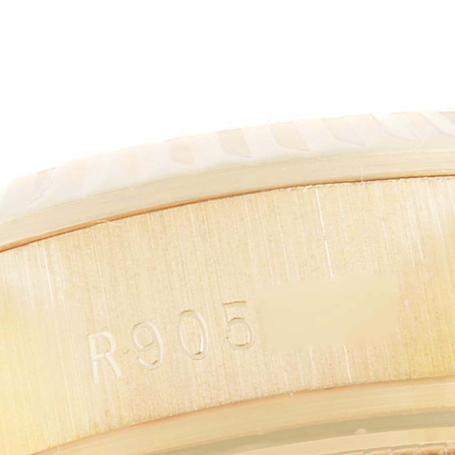 This close-up image shows the engraved serial number on the side of the case of a Rolex President 69178 Women's Yellow Gold Champagne Dial 69178 Women's Yellow Gold Champagne Dial model watch.