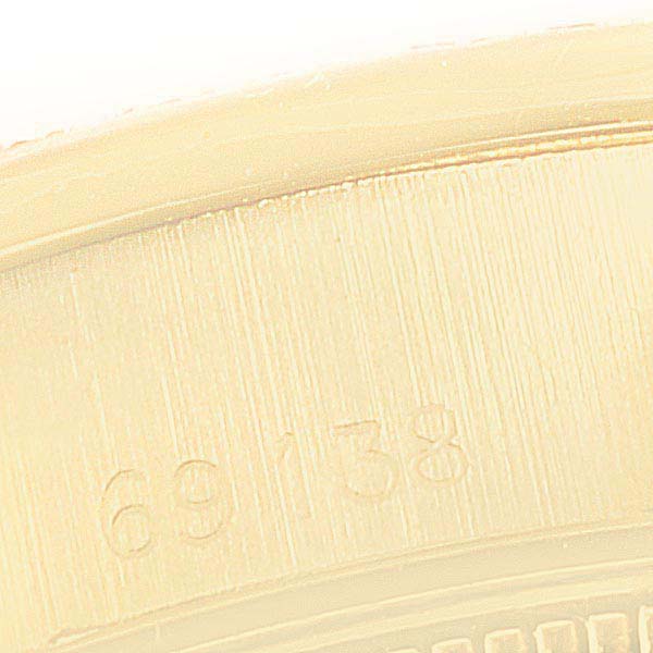 This image shows the serial number engraving on the case of a Rolex President 69138 Women's Yellow Gold Mother of Pearl Dial 69138 Women's Yellow Gold Mother of Pearl Dial model watch.