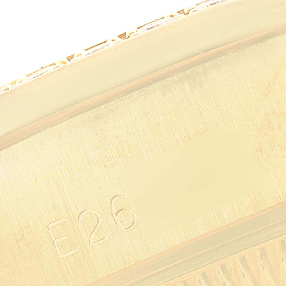 The image shows a close-up of the side of a Rolex President 69138 Women's Yellow Gold Mother of Pearl Dial 69138 Women's Yellow Gold Mother of Pearl Dial model watch, highlighting its serial number and part of the bezel.