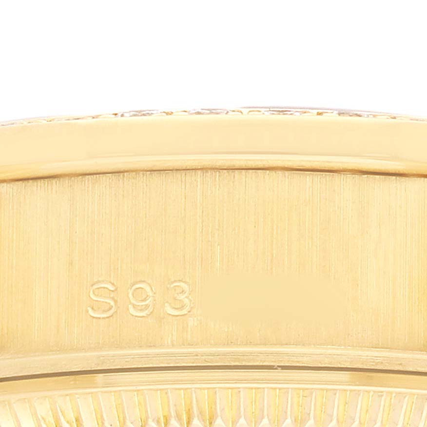 This close-up image shows the side engraving on the bezel of a Rolex President 69158 Women's Yellow Gold Champagne Dial model watch.