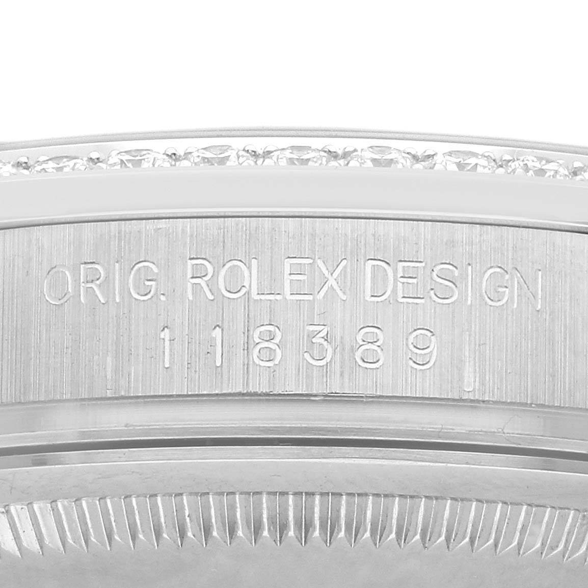 The image shows a close-up of the case side of a Rolex President 118389 Men's White Gold Silver Dial watch, highlighting the model number and design engraving.