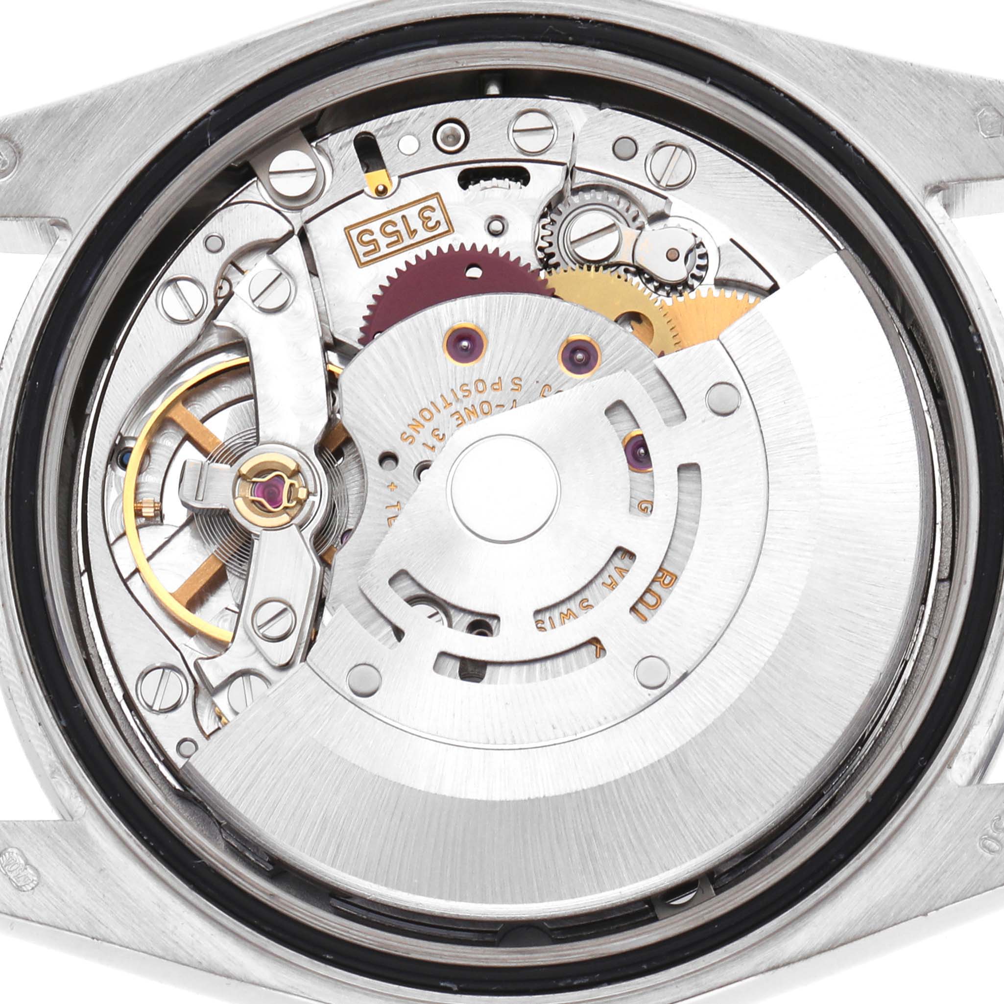 This image shows the internal mechanism of a Rolex President 118389 Men's White Gold Silver Dial model, highlighting gears and movement parts from a top-down angle.