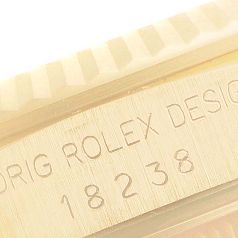 This image shows a close-up of the side of the Rolex President 18238 Men's Yellow Gold Champagne Dial 18238 Men's Yellow Gold Champagne Dial model watch, highlighting its engraved serial number.