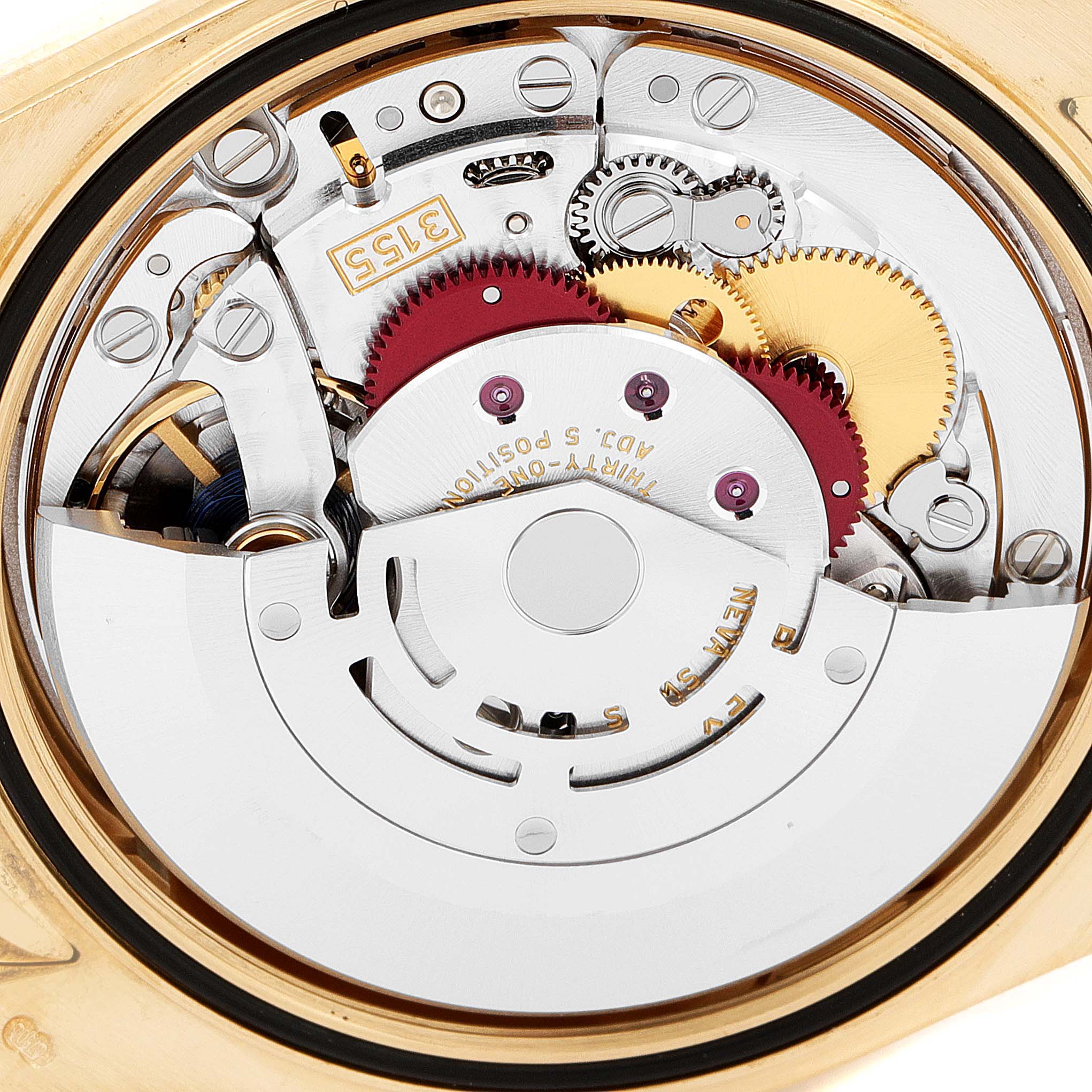 The image shows the intricate inner mechanics of a Rolex President 118139 Men's Yellow Gold Brown Dial 118139 Men's Yellow Gold Brown Dial model watch from a back angle, highlighting its gears and movement.