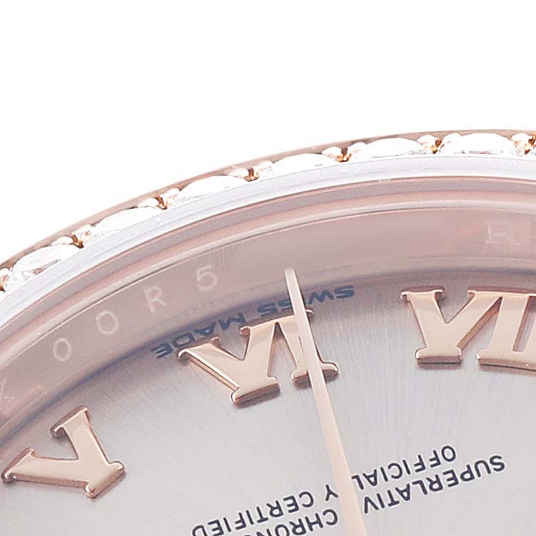 This close-up shows part of the dial and bezel with diamond accents on the Rolex President 279135 Women's Rose Gold Pink Dial model.