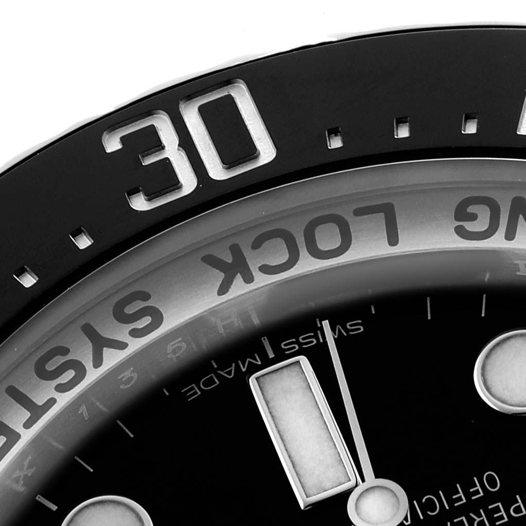 The image shows a close-up of the bezel, dial, and part of the hands of the Rolex Sea-Dweller 116660 Men's Stainless Steel Blue Dial watch model.