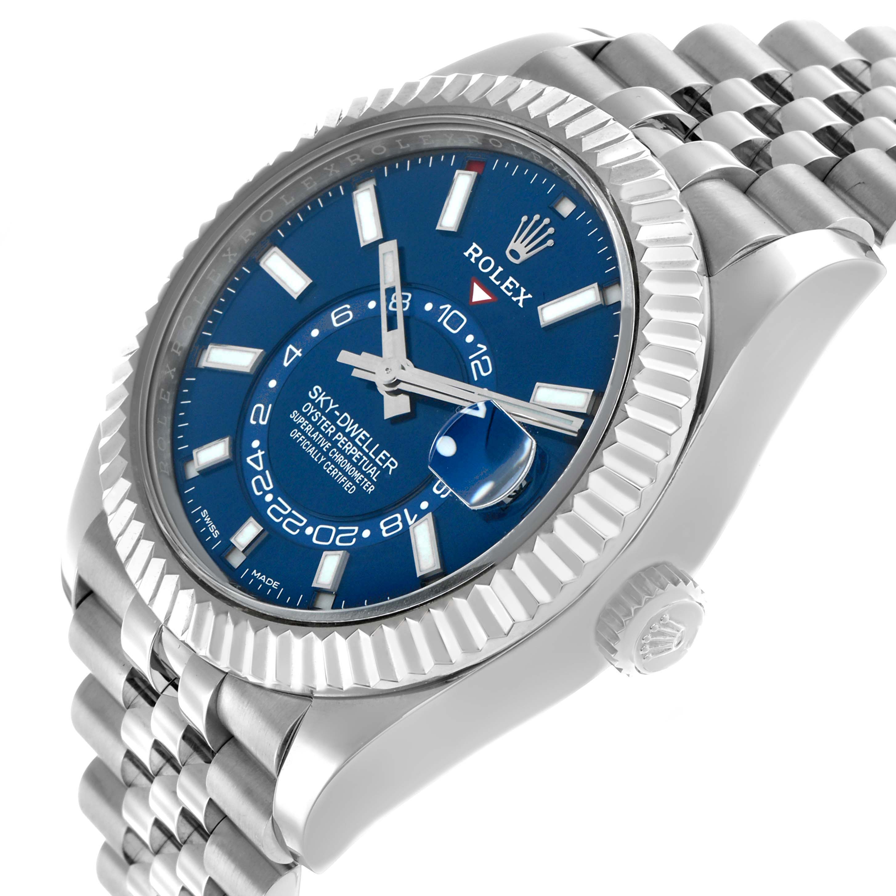 The Rolex Sky-Dweller 326934 Men's Stainless Steel Blue Dial is shown at an oblique angle, displaying the face, crown, and bracelet with a blue dial and fluted bezel.