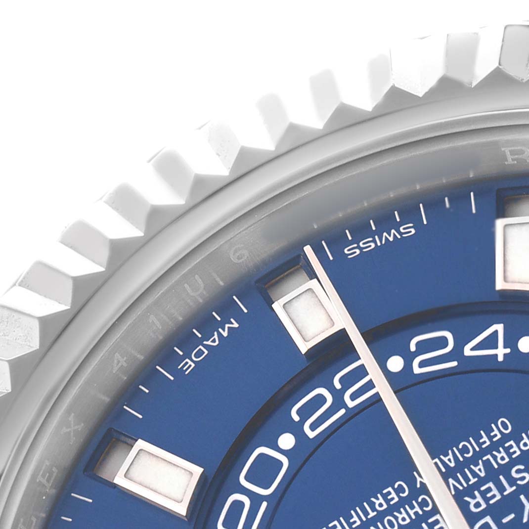 The image shows a close-up of the bezel and part of the blue dial of a Rolex Sky-Dweller 326934 Men's Stainless Steel Blue Dial watch.