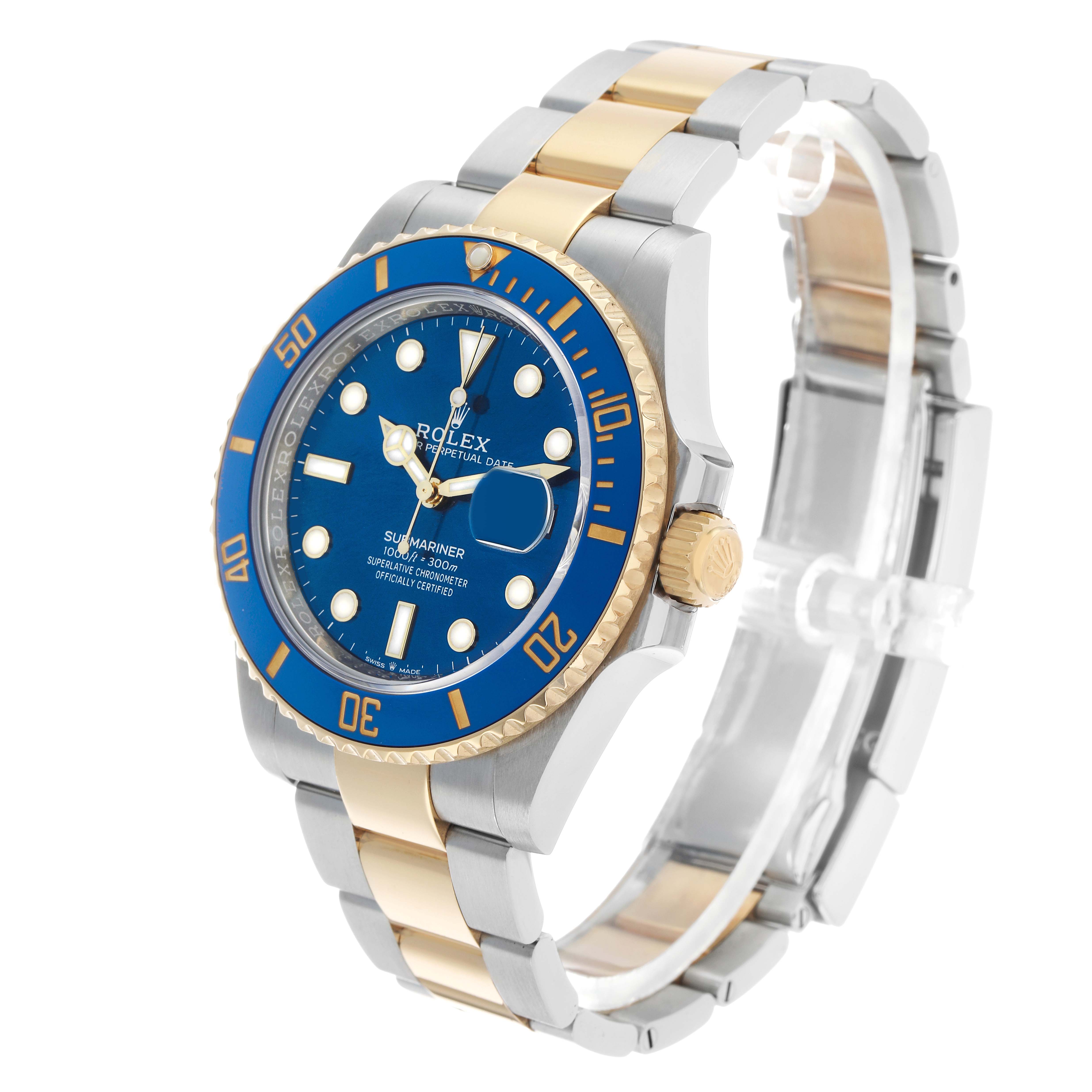 The Rolex Submariner 126613 Men's Steel and Gold (two tone) Blue Dial is shown at a three-quarter angle, highlighting the blue and gold bezel, dial, and two-tone bracelet.