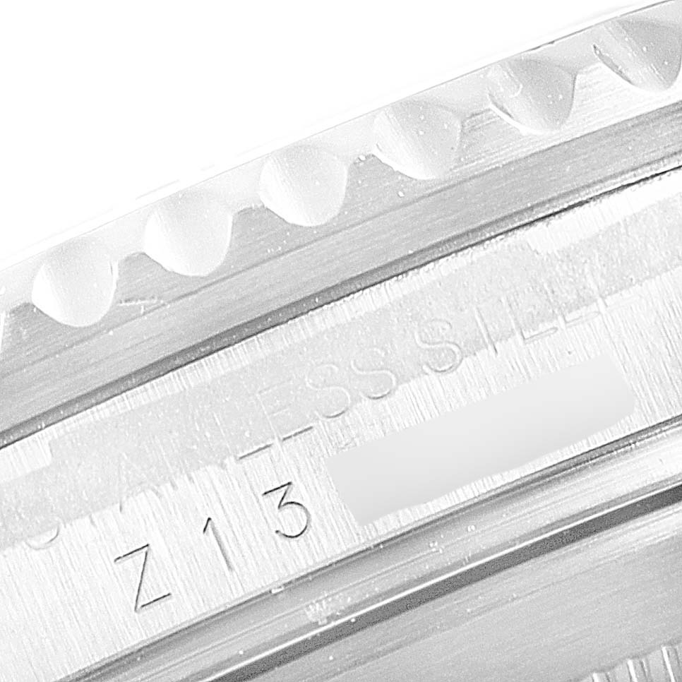 This close-up image shows the engraved edge of the bezel and caseback of a Rolex Submariner 16610 Men's Stainless Steel Black Dial 16610 Men's Stainless Steel Black Dial model watch.